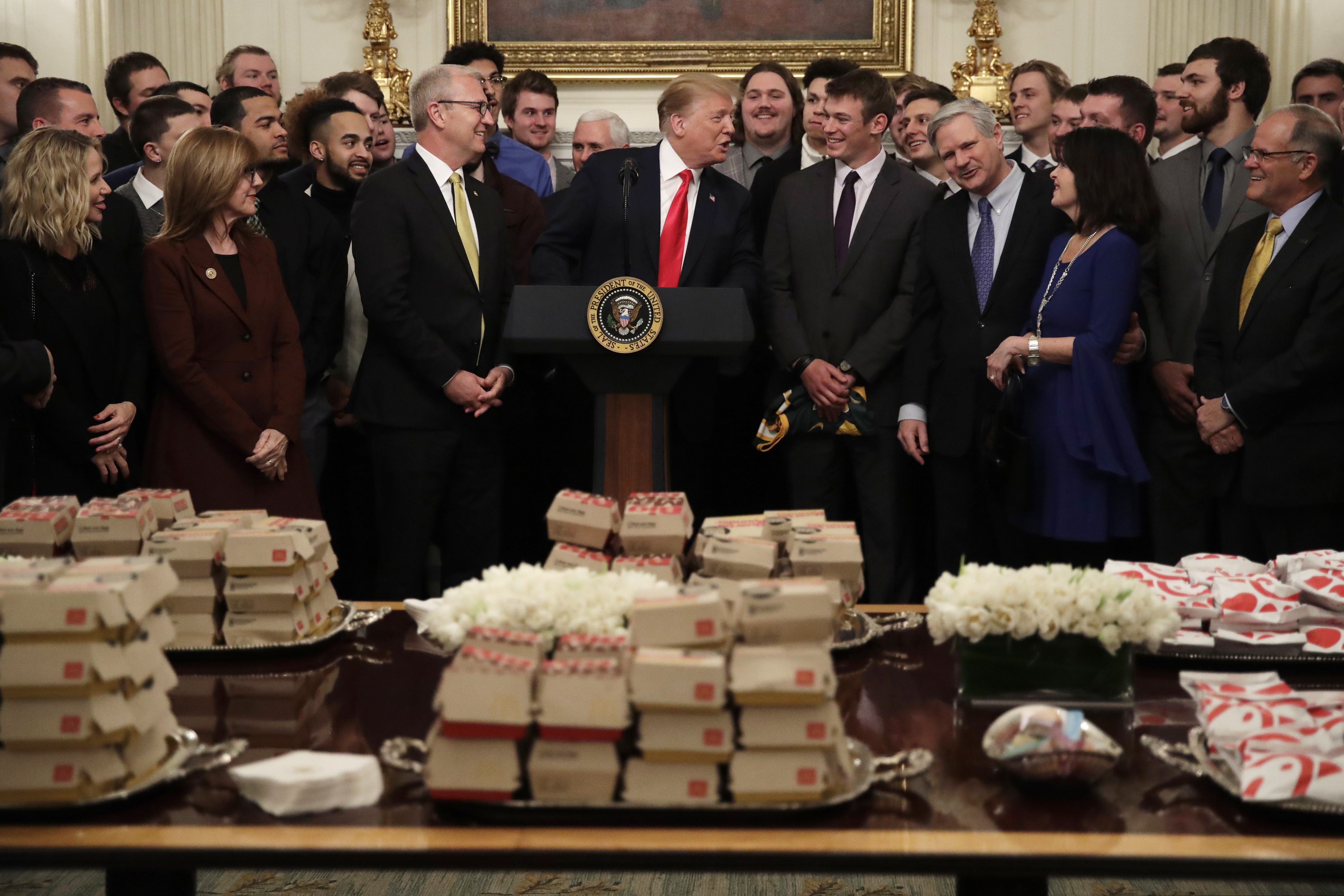 (Carolyn Kaster | The Associated Press) President Donald Trump welcomes the 2018 NCAA FCS College Football Champions, The North Dakota State Bison, to the State Dining room of the White House in Washington, Monday, March 4, 2019, with McDonald's and Chick-fil-A fast food. Fourth from left is Sen. Kevin Cramer, R-N.D., third right is Sen. John Hoeven, R-N.D., and fourth from right is North Dakota State Bison quarterback Easton Stick.