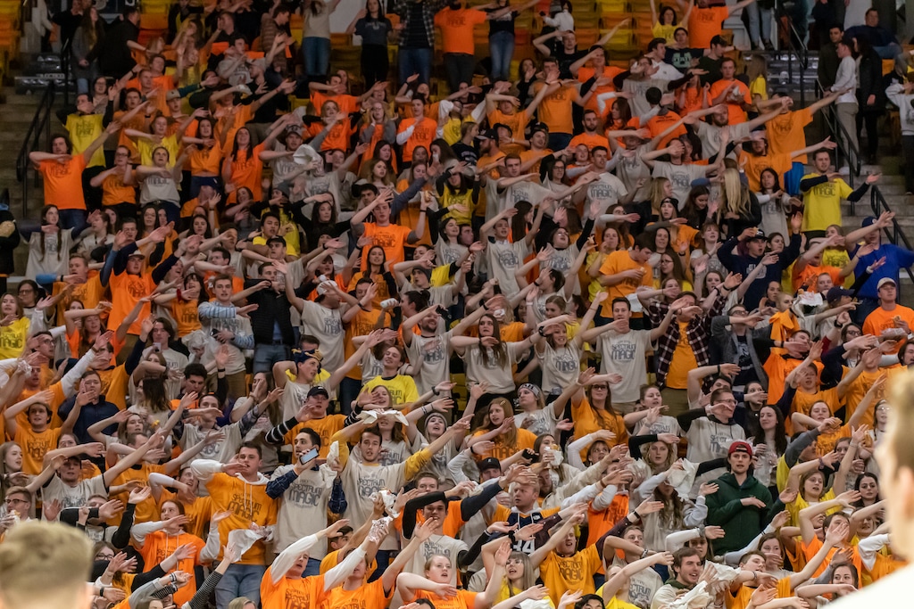 (Photo courtesy of Utah State Athletics) Members of The Hurd, Utah State’s student section, wave their arms in unison  during a game against University of Nevada, Las Vegas, at the Spectrum in Logan on Feb. 5, 2020.