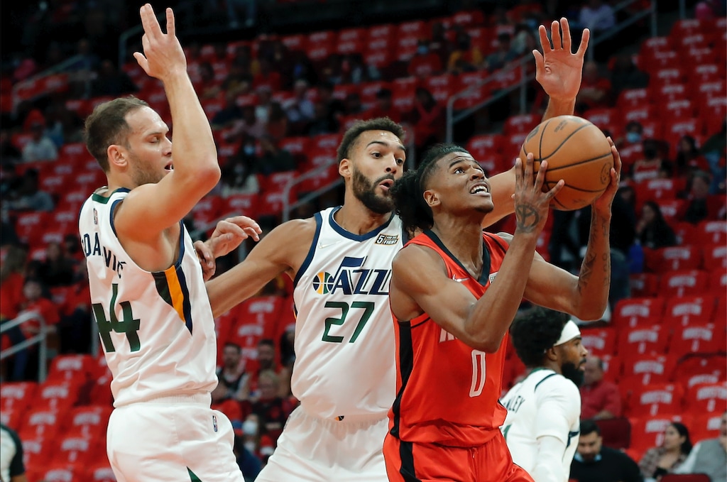 Houston Rockets guard Jalen Green (0) looks to shoot in front of Utah Jazz forward Bojan Bogdanovic (44) and center Rudy Gobert (27) during the first half of an NBA basketball game Thursday, Oct. 28, 2021, in Houston. (AP Photo/Michael Wyke)