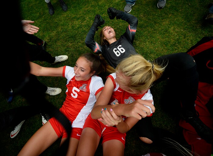 (Scott Sommerdorf   |  The Salt Lake Tribune)   American Fork goalkeeper Haven Empey, top, celebrates with team mates after they beat Syracuse 3-1 to win the 6A championship game played at Rio Tinto, Friday, October 20, 2017. 