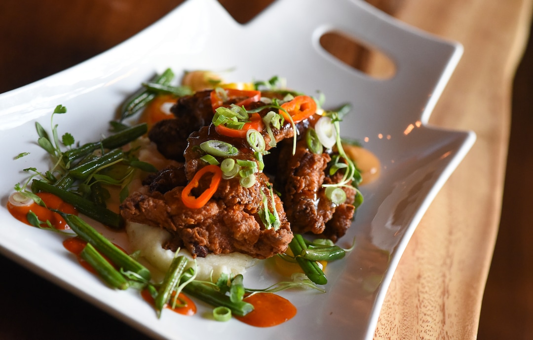 (Francisco Kjolseth  |  The Salt Lake Tribune)  Miso fried chicken with ponzu gastrique, butter mash, tamari blistered green beans, scallions, cilantro, pickled chili peppers and harissa aioli at the new London Belle Supper Club, a new Salt Lake City bar named after Belle London, a famous Utah madam, at 321 S. Main.