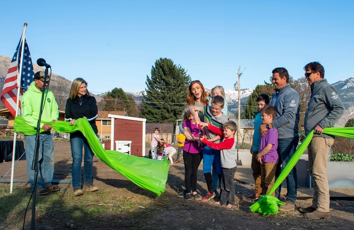 (Rick Egan | The Salt Lake Tribune)  Jenny Taylor and her kids, Red sleeves Jonathan, Jacob, Eleanor and Caroline
Cut the ribbon, during the Earth Day Party at the Mini Taylor farm at at the Jennie Taylor's residence, in North Ogden. Taylor is the widow to the late Major. Brent Taylor, killed in 2018 while on Army National Guard duty in Afghanistan, donations have helped restore the small family farm, with planter boxes, a chicken coop, and a sandbox for the kids, on Thursday, April 22, 2021.