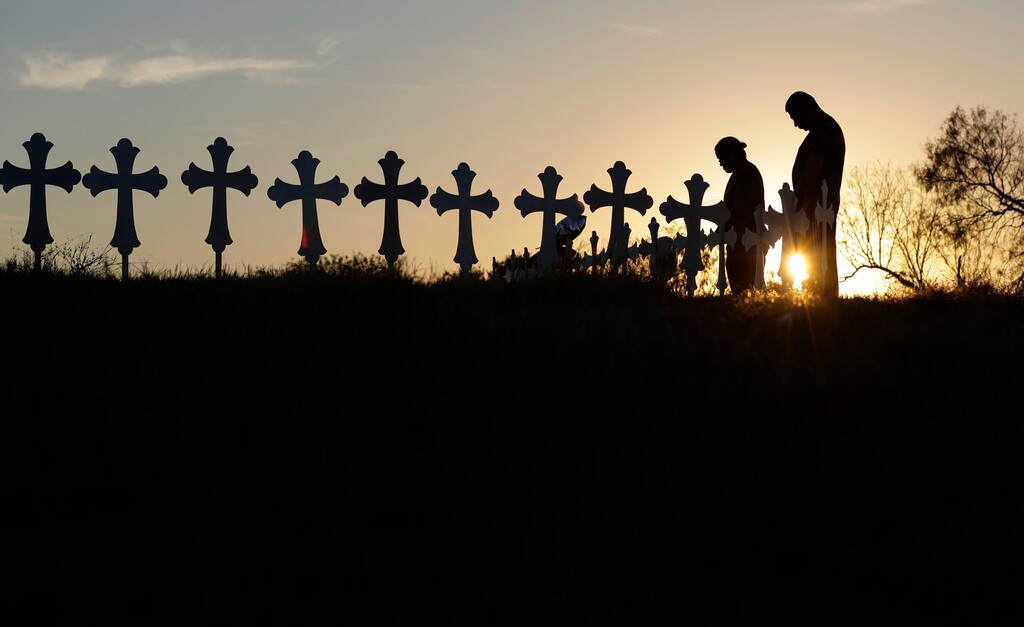 (Eric Gay | The Associated Press) Kenneth and Irene Hernandez pay their respects as they visit a makeshift memorial with crosses placed near the scene of a shooting at the First Baptist Church on Nov. 6, 2017, in Sutherland Springs, Texas. A man opened fire inside the church in the small South Texas community killing more than two dozen and injuring others.