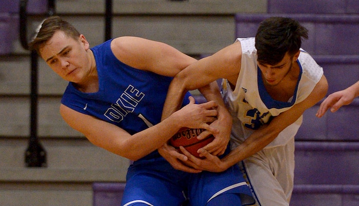 (Leah Hogsten  |  The Salt Lake Tribune) Dixie'sPayton Wilgar battles Cyprus' Ryan Bryce for the rebound.  Dixie High School defeated Cyprus High School boys' basketball team 59-52 during the Riverton Holiday Tournament in Riverton, December 28, 2017. 