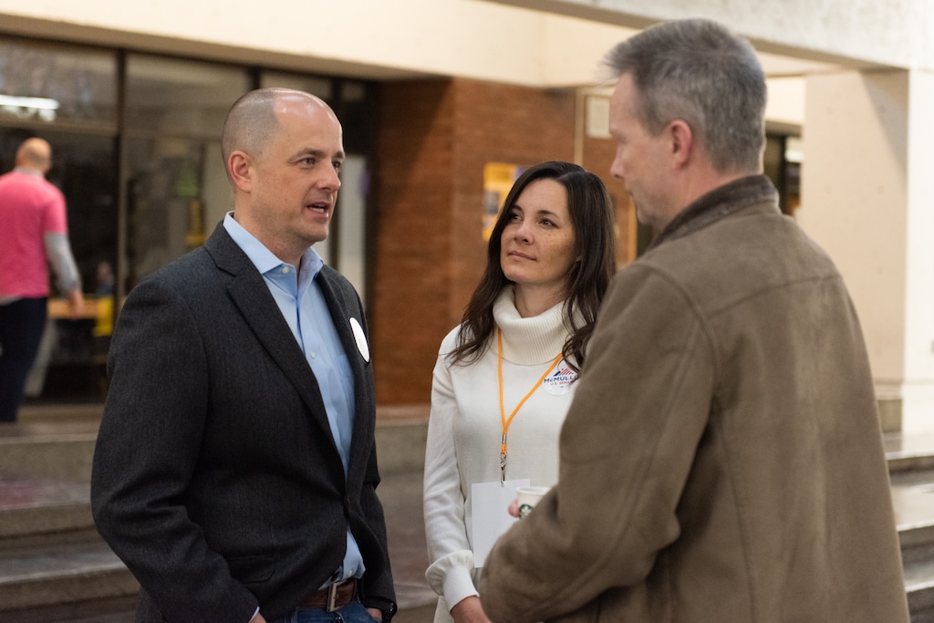 (Briana Scroggins | Special to The Tribune) Utah independent Evan McMullin, his wife, Emily and Democratic delegate Richard Whitney talk during the Utah Democratic Convention at Cottonwood High School in Murray, Utah on Saturday, April 23, 2022.