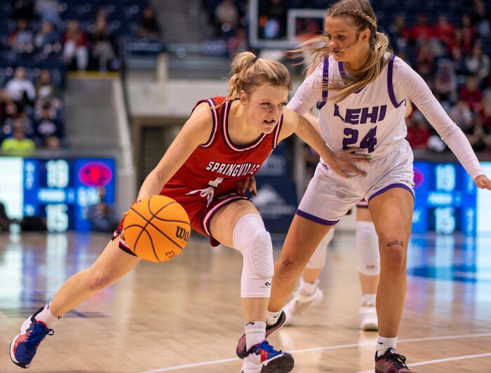 (Rick Egan | The Salt Lake Tribune) Springville Red Devils guard, Ellie Esplin (1) drives to the basket as Lehi guard, Sammi Love (24) defends, in the girls 5A State Championship game between the Springville Red Devils and the Lehi Pioneers, at the Marriott Center in Provo, on Saturday, March 5, 2022. 
