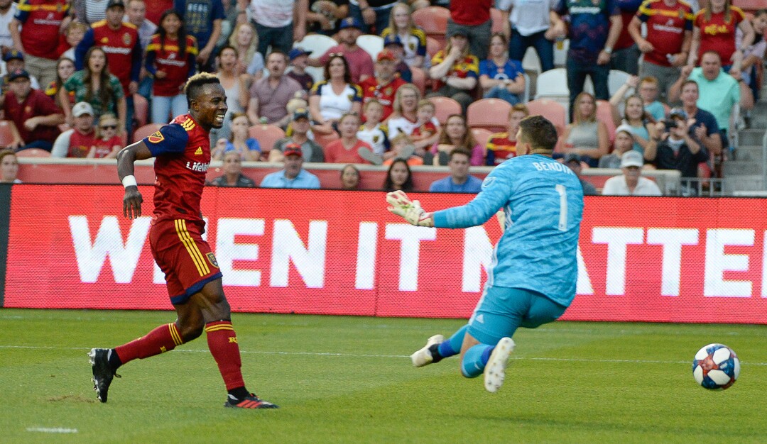 (Francisco Kjolseth  |  The Salt Lake Tribune)  Real Salt Lake forward Sam Johnson (50) scores the first goal of the night on Columbus Crew goalkeeper Joseph Bendik (1) on as Real Salt Lake hosts Columbus Crew SC, in MLS Soccer at Rio Tinto Stadium in Sandy, Utah on Wed, July 3, 2019.