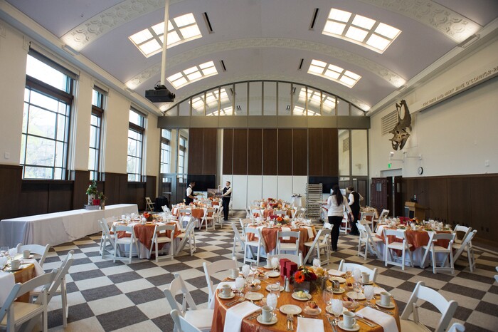 (Rick Egan  |  The Salt Lake Tribune)     Workers set up for a luncheon in the room that used to house the dinosaur display, at the Ann Crocker Science Center on Presidents Circle, at the University of Utah, Thursday, April 19, 2018.


