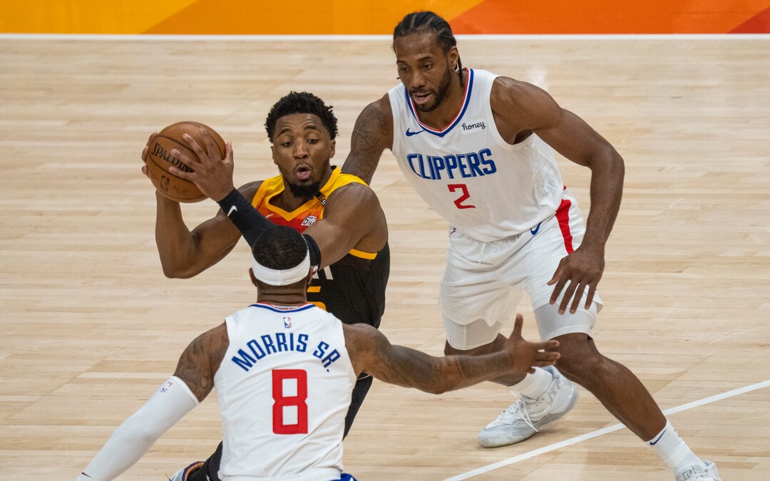 (Rick Egan | The Salt Lake Tribune) Donovan Mitchell (45) splits the LA defenders, forward Kawhi Leonard (2)] and Clippers forward Marcus Morris Sr. (8) to score for the Jazz, in NBA action between the Utah Jazz and the LA Clippers, in game one in the second round of the NBA playoff series at Vivint Arena, on Tuesday, June 8, 2021.