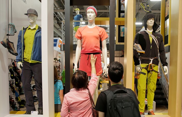 A woman reaches to touch the fabric on a mannequin at the La Sportiva booth during the Outdoor Retailer show Friday, Aug. 5, 2016, in Salt Lake City. A wide array of clothing, gear and equipment specifically designed for women outdoor adventurers is on display at the summer version of the world's largest outdoor gear show for retailers that brings thousands of people to Salt Lake City. (AP Photo/Rick Bowmer)