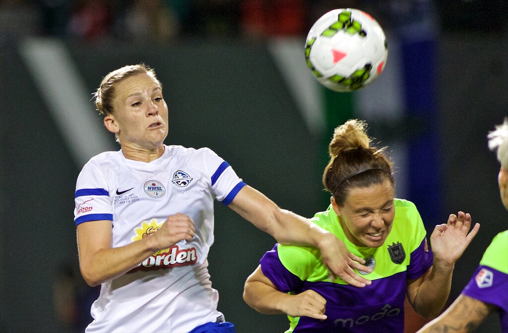 FC Kansas City forward Amy Rodriguez, left, heads the ball away from Seattle Reign FC defender Rachel Corsie during the second half of the NWSL soccer championship match in Portland, Ore., Thursday, Oct. 1, 2015. FC Kansas City won the match 1-0. (AP Photo/Craig Mitchelldyer)