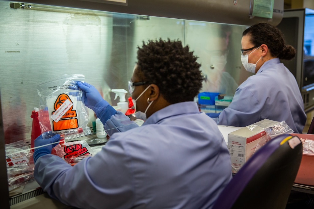 Clinical technicians process samples of potential coronavirus at the virology lab of the University of Washington in Seattle, March 6, 2020. Frustration is mounting as state officials, doctors and patients are clamoring for coronavirus tests that are still not available, despite the nearly daily assurances otherwise from President Donald Trump and other members of his administration. (Andrew Burton/The New York Times)