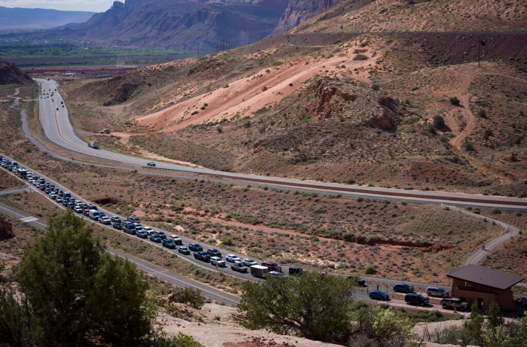 (Bethany Baker  |  The Salt Lake Tribune) Tourists line up to enter Arches National Park near Moab on Thursday, April 9, 2026.