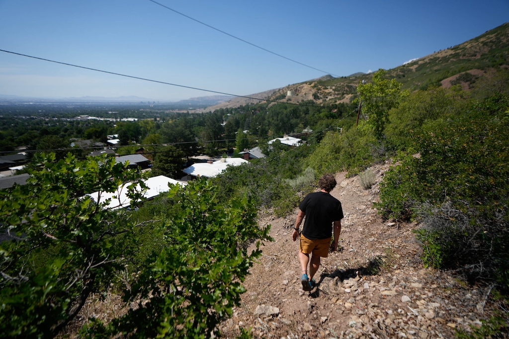 (Francisco Kjolseth | The Salt Lake Tribune) Ryan Stefani walks a trail behind his house in the benches near the mouth of Millcreek Canyon on Wednesday, July 15, 2027. Living so close to open space has its tradeoffs as he recounts the various wildfires that have erupted near his house in years past.
