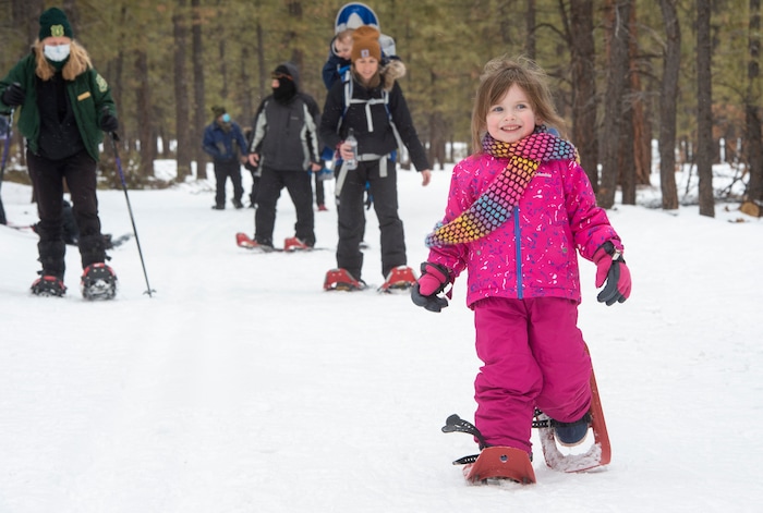 (Rick Egan | The Salt Lake Tribune) Three-year-old MacKenzie Flynn, from Draper, takes a tour of the Dixie National Forest on a snowshoes, during the 36th annual Ruby's Inn Bryce Canyon Winter Festival on Saturday, Feb. 13, 2021.