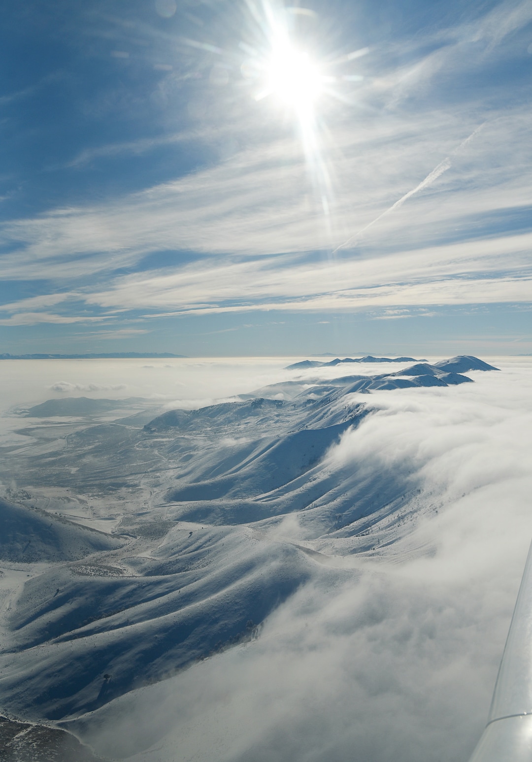 (Francisco Kjolseth  |  The Salt Lake Tribune)  The Promontory Mountains and the Wasatch Range beyond push through the deteriorating air quality under inversion conditions on Monday, Jan. 14, 2019, obscuring the ground below as pilot Jeff Greenland takes every opportunity to fly above the poor conditions. Over the radio with Salt Lake Approach before landing he can be heard saying "thanks for keeping us all safe during the shutdown," as the longest government shutdown in U.S. history drags on.