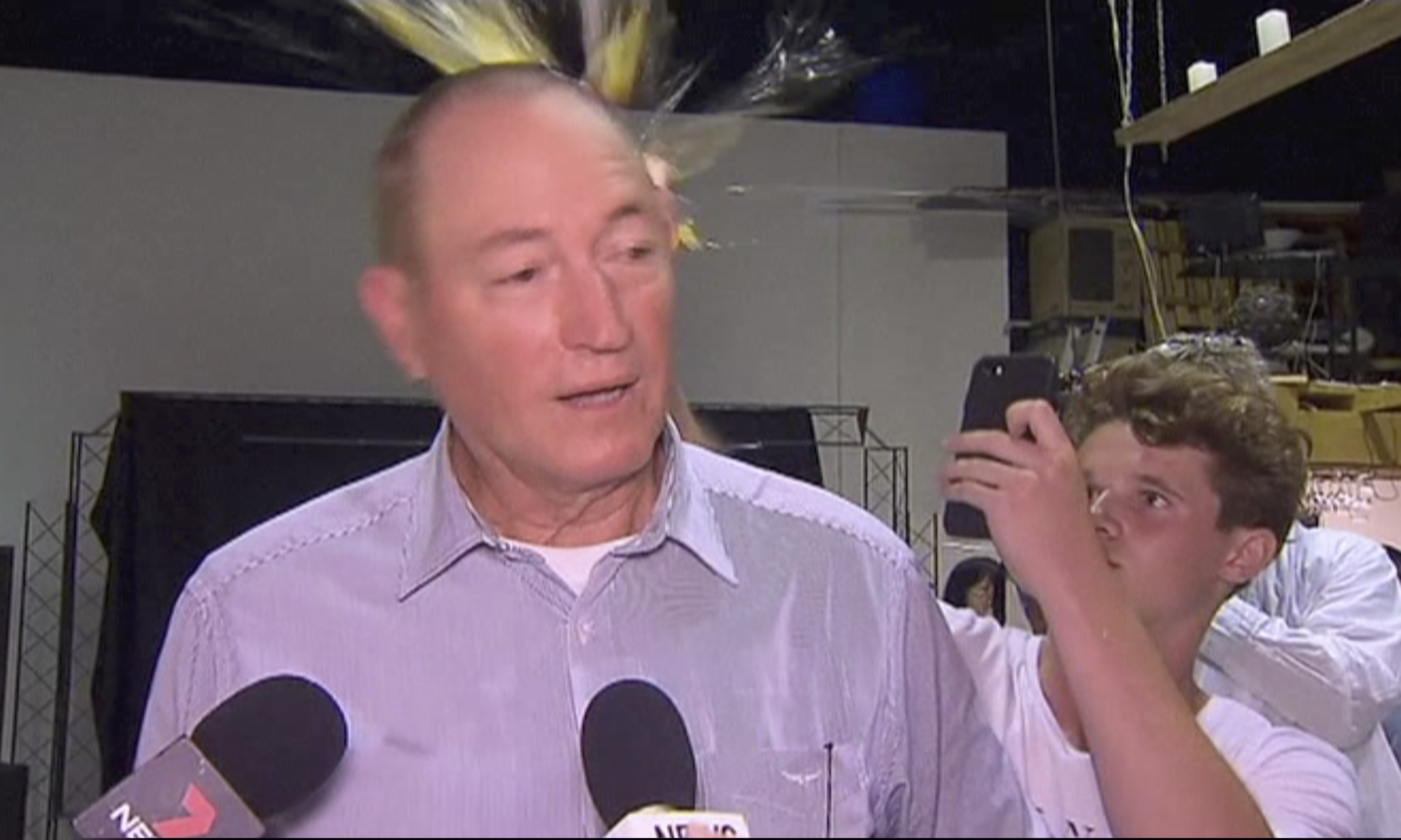 (AP Photo) In this image made from video, a teenager breaks an egg on the head of Senator Fraser Anning while he holds a press conference, Saturday, March 16, 2019, in Melbourne, New Zealand. Following the mass shootings on Friday, Anning came under sharp criticism over tweets including one that said: “Does anyone still dispute the link between Muslim immigration and violence?”