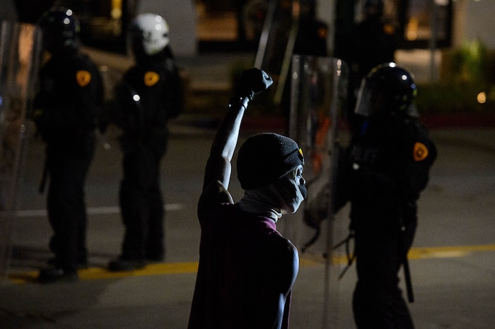 (Trent Nelson  |  The Salt Lake Tribune) Protesters face a line of police while marching through Salt Lake City after curfew on Monday, June 1, 2020.