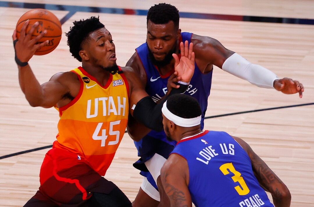 Utah Jazz's Donovan Mitchell drives against Denver Nuggets' Paul Millsap and Torrey Craig (3) during the fourth quarter of Game 4 of an NBA basketball first-round playoff series, Sunday, Aug. 23, 2020, in Lake Buena Vista, Fla. (Kevin C. Cox/Pool Photo via AP)