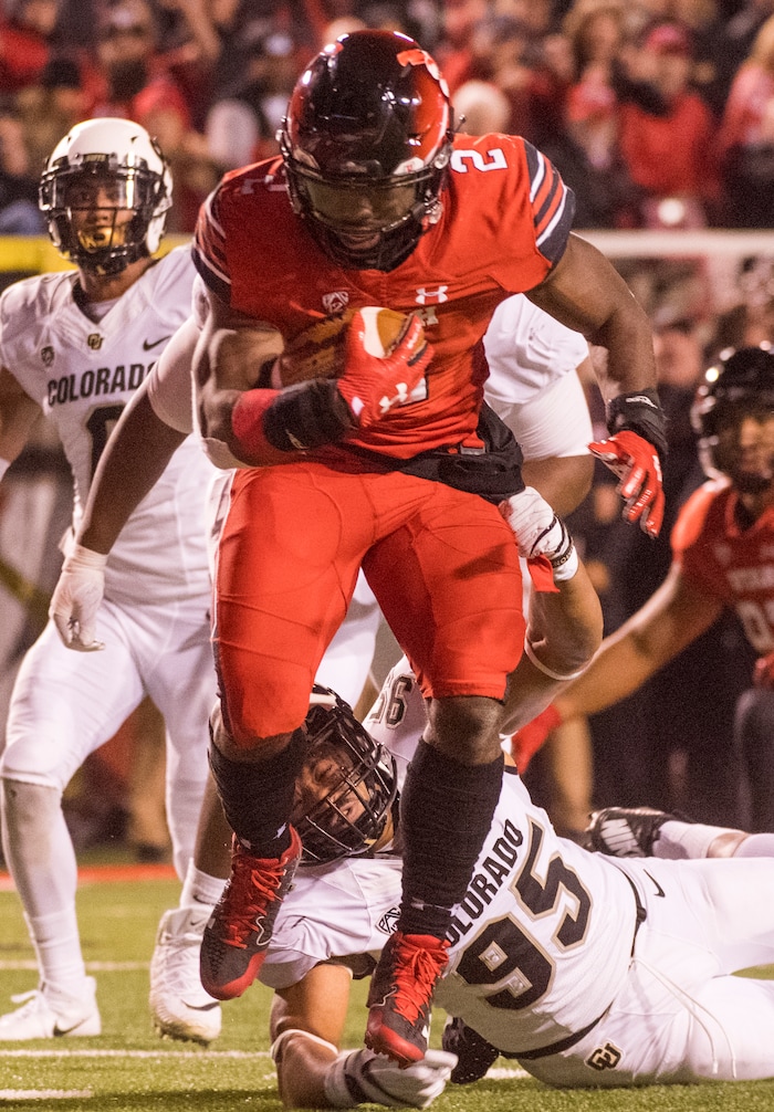 (Rick Egan  |  The Salt Lake Tribune)  Utah Utes running back Zack Moss (2) gets past Colorado Buffaloes defensive back Ryan Moeller (25) for a touchdown, in PAC-12 football action Utah Utes vs. Colorado Buffaloes at Rice-Eccles stadium, Saturday, November 25, 2017.