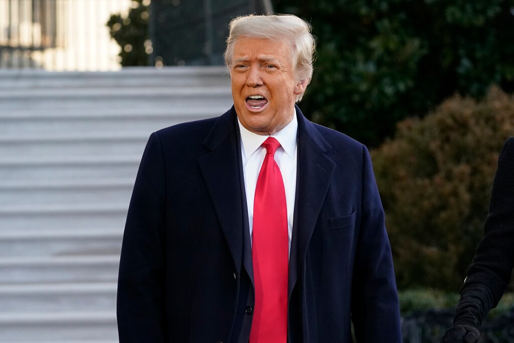 President Donald Trump speaks with reporters as he walks to board Marine One on the South Lawn of the White House, Wednesday, Jan. 20, 2021, in Washington. Trump is en route to his Mar-a-Lago Florida Resort. (AP Photo/Alex Brandon)