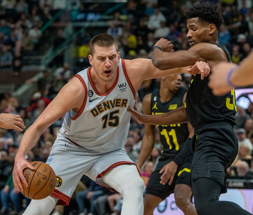 (Rick Egan | The Salt Lake Tribune) Denver Nuggets center Nikola Jokic (15) moves toward the hoop, as Utah Jazz forward Juan Toscano-Anderson (95) defends, in NBA action between the Utah Jazz and the Denver Nuggets at Vivint Arena,  Saturday, April 8, 2023.
