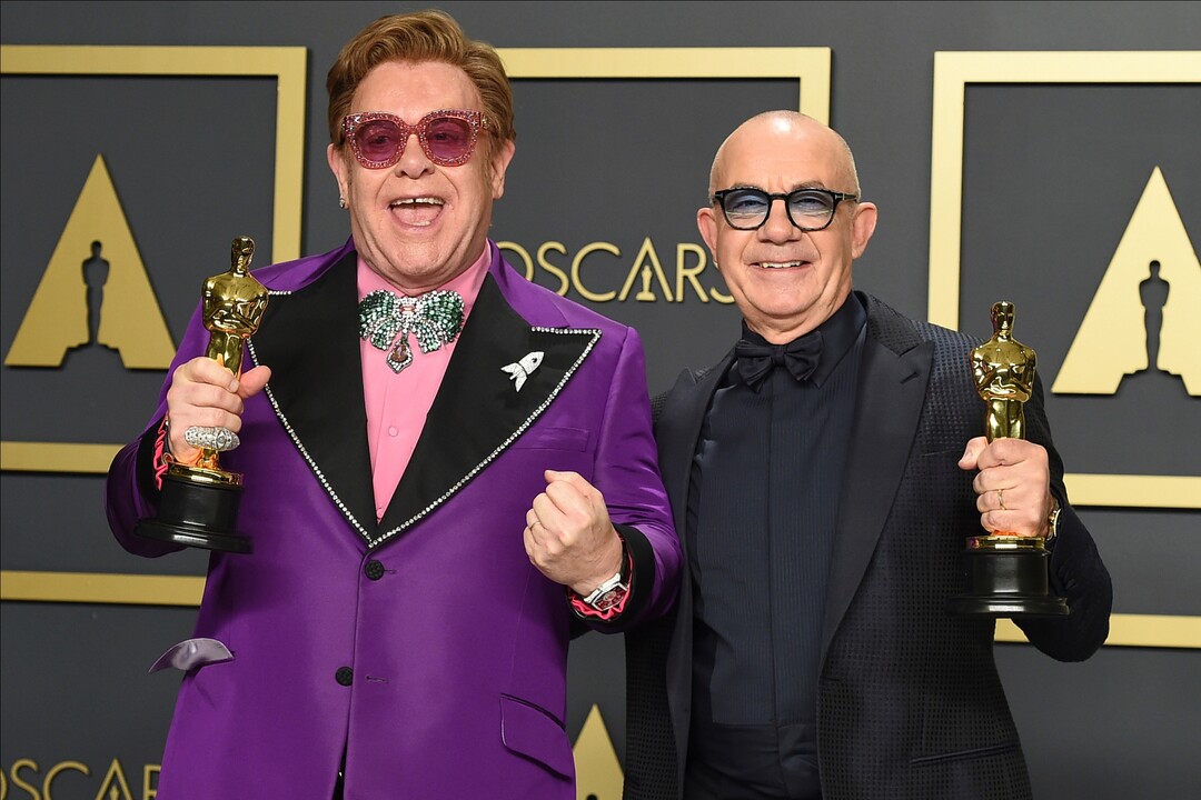 (Jordan Strauss | Invision/AP)  Elton John, left, and Bernie Taupin, winners of the award for best original song for "(I'm Gonna) Love Me Again" from "Rocketman", pose in the press room at the Oscars on Sunday, Feb. 9, 2020, at the Dolby Theatre in Los Angeles.