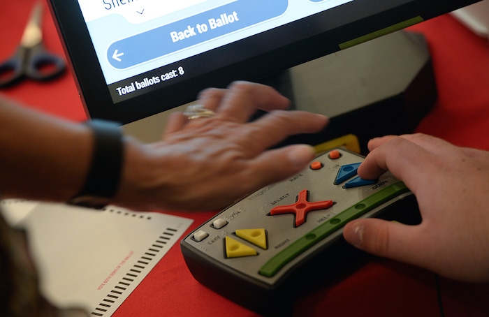(Francisco Kjolseth  |  The Salt Lake Tribune)  Companies demonstrate new voting machines that can also be navigated by the visually impaired during a hands on presentation at the Capitol on Wednesday, Aug. 2, 2017. The state is considering buying new voting machines. 