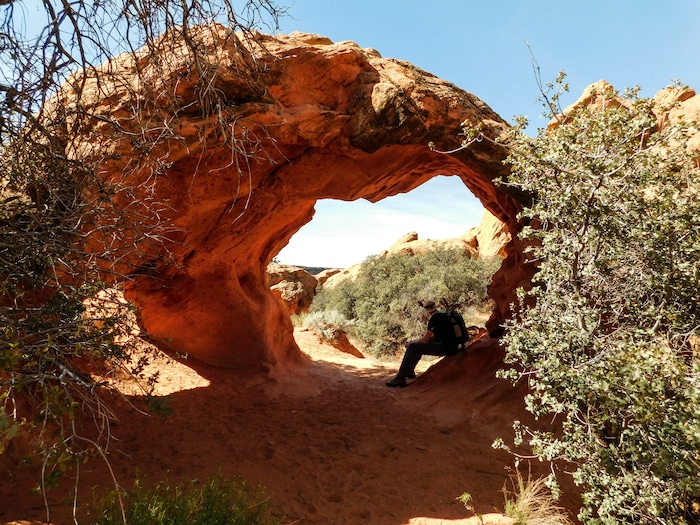 Erin Alberty  |  The Salt Lake TribuneA hiker rests in the shade of Babylon Arch on March 12, 2017 in the Red Cliffs Desert Reserve near Leeds.