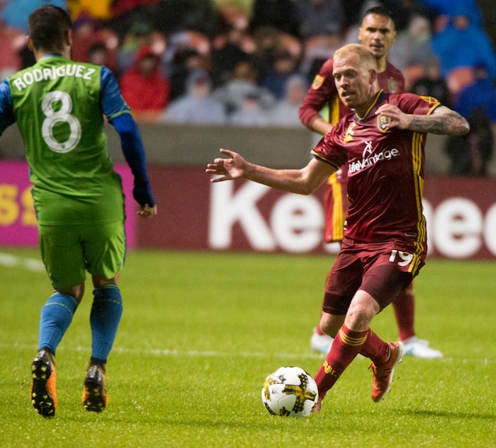 (Rick Egan  |  The Salt Lake Tribune) Real Salt Lake midfielder Luke Mulholland (19) brings the ball down field, as Seattle Sounders midfielder Victor Rodriguez (8) defends, in MLS soccer action, Real Salt Lake vs Seattle Sounders, in Sandy, Saturday, September 23, 2017.