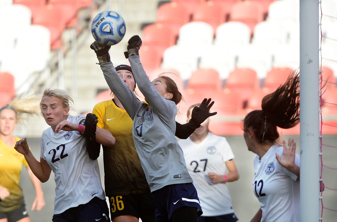 (Scott Sommerdorf   |  The Salt Lake Tribune)   Timpanogos goalkeeper Mia Barlow reaches to make a save as Maple Mountain's Tennessee Schellenberg has her on on the ball during first half play. Maple Mountain won the shootout period after double overtime to win the 5A championship game over Timpanogos, Friday, October 20, 2017. 