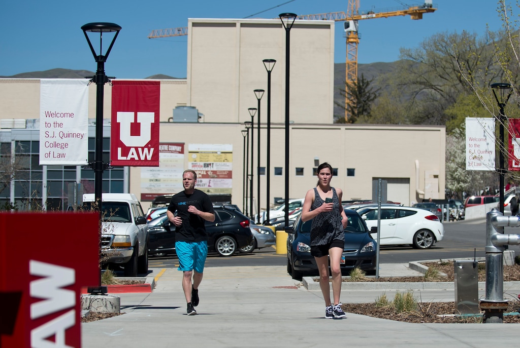 Lennie Mahler | The Salt Lake Tribune
University of Utah law students Scott Manning and Brooke Parrish cross the finish line of a mile route around campus Thursday, April 7, 2016. Law students and faculty worked to accumulate a total of 100 miles before law school dean Robert Adler runs a 100-mile course in Zion National Park on Friday. Adler will run the ultra-marathon to push for a 100% bar exam passage rate and 100% employment for law graduates.