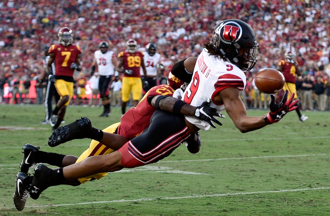 Utah wide receiver Darren Carrington II (9) attempts to catch the ball while Southern California cornerback Ajene Harris defends during the first half of an NCAA college football game in Los Angeles, Saturday, Oct. 14, 2017. The play resulted in a call of pass interference. (AP Photo/Kelvin Kuo)