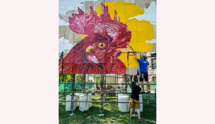 (Rick Egan | The Salt Lake Tribune) Dave and Mason Fetzer hang the PZLMRL, a puzzle mural, in which 100 artists painted 100 squares to make a puzzle mural, at the Salt Lake Arts Festival, on Saturday, Aug. 28, 2021.