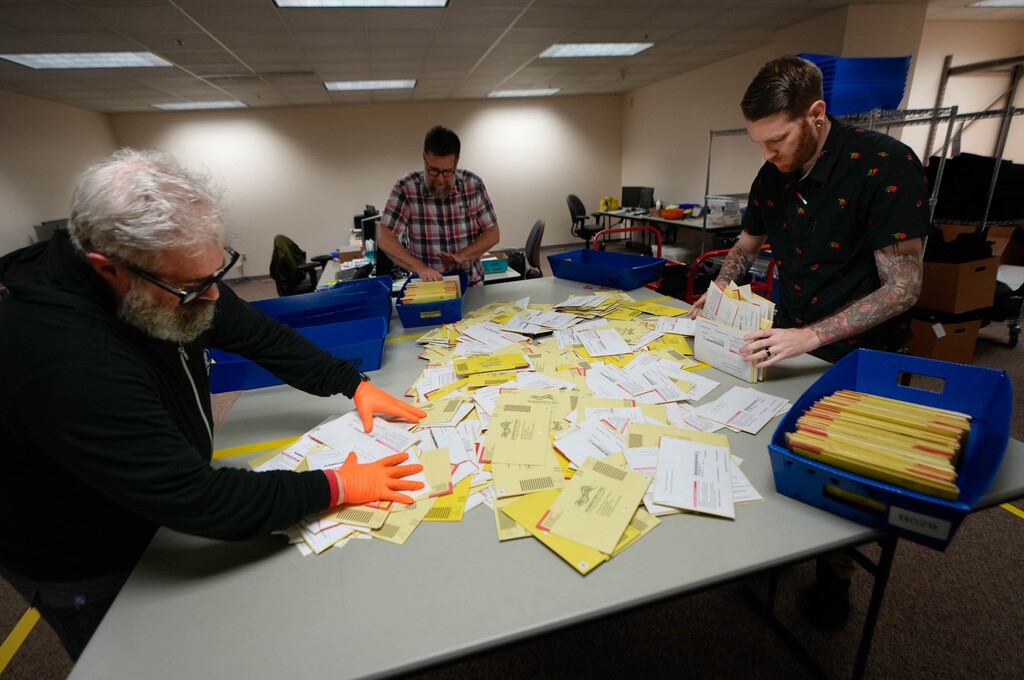 (Francisco Kjolseth | The Salt Lake Tribune) Election workers sort vote-by-mail ballots at the Salt Lake County ballot processing center on Tuesday, Nov. 8, 2022.