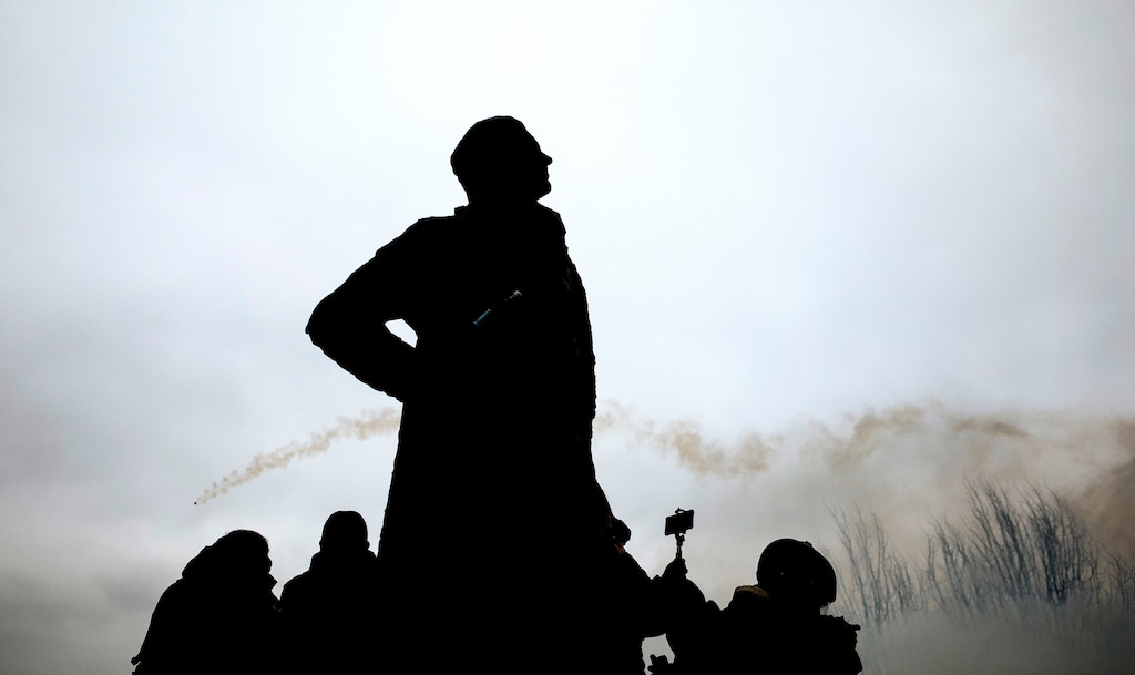 (Kamil Zihnioglu | Associated Press file photo)  A tear gas canister fired by riot police flies behind the statue of Thomas Jefferson, the third president of the United States, during a protest in Paris on Jan. 5, 2019.