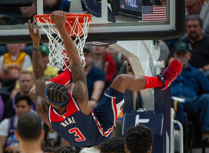(Rick Egan  |  The Salt Lake Tribune)     Washington Wizards guard Bradley Beal (3) swings on the rim after dunking the ball, in NBA action between the Utah Jazz and the Washington Wizards, in Salt Lake City, Friday, February 28, 2020