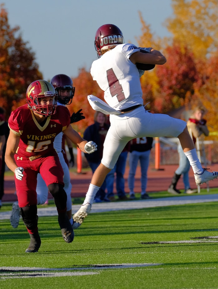 (Leah Hogsten  |  The Salt Lake Tribune) Viewmont's Cole Salmon gets ready to take down Jordan's Ethan Bolingbrooke. Jordan High School boys' football team defeated Viewmont High School 28-20 during their class 5A football playoff opener, Friday, October 27, 2017 in Bountiful.