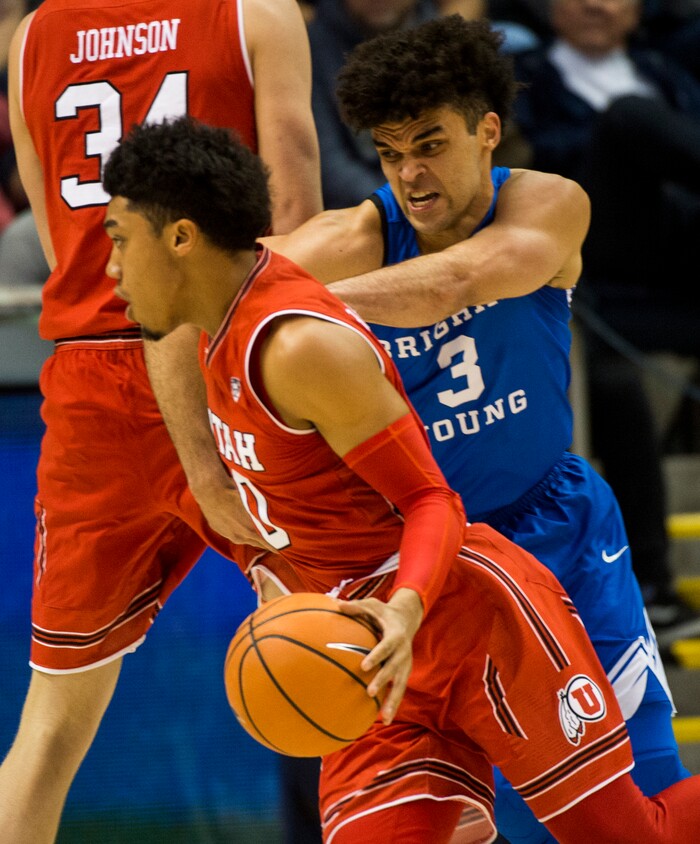 (Rick Egan  |  The Salt Lake Tribune)  Brigham Young Cougars guard Elijah Bryant (3) tries to get around a Utah Utes forward Jayce Johnson (34) screen as he guards Utah Utes guard Sedrick Barefield (0), in basketball action Utah Utes vs. Brigham Young Cougars at the Marriott Center in Provo, Saturday, December 15, 2017.



