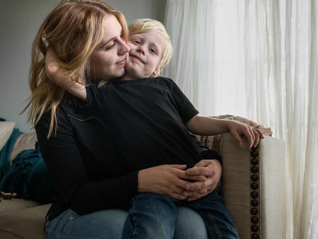 (Leah Hogsten | The Salt Lake Tribune) Rae Edwards gets a hug from her 5-year-old son Frankie in their home in Cody, Wyo., Sept. 30, 2022. Edwards remembers testifying while pregnant with her son during then-Utah State University football player Torrey Green’s preliminary hearing on sex assault charges in 2017.