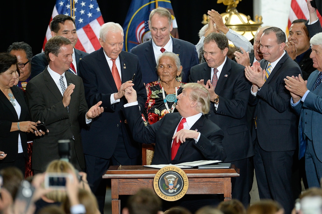 (Francisco Kjolseth  |  The Salt Lake Tribune)  U.S. President Donald Trump, surrounded by Utah representatives looks at Sen. Orrin Hatch to give him the pen used to signs a presidential proclamation to shrink Bears Ears and Grand Staircase-Escalante national monuments at the Utah Capitol on Monday, Dec. 4, 2017.
