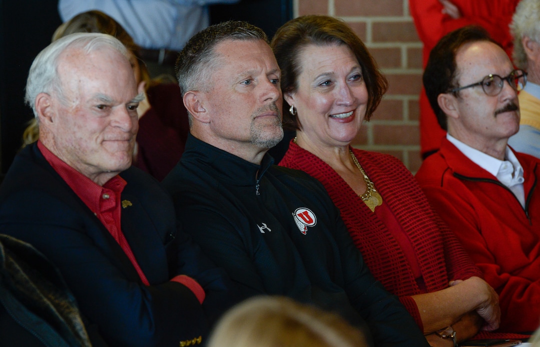 (Francisco Kjolseth  |  The Salt Lake Tribune)  Philanthropist Spencer F. Eccles, University of Utah football coach Kyle Whittingham, U. President Ruth Watkins and philanthropist Tom McCarthey, from left, attend the retirement announcement of Athletics Director Chris Hill after 31years. Joined by his wife Kathy and their kids and grandkids at the Jon M. Huntsman Center on campus on Monday, March 26, 2018, Hill is the longest actively tenured athletics director at the same school in the NCAA FBS.