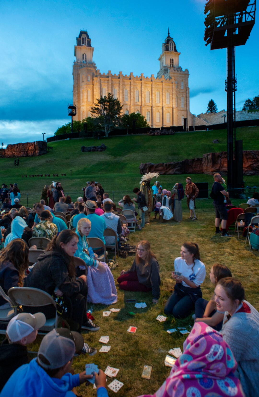 (Rick Egan  |  The Salt Lake Tribune)    Audience members play cards while they wait for the 9:30 start of the Mormon Miracle Pageant, Wednesday, June 12, 2019.  The final run for the pageant continues through Saturday, June 22.
