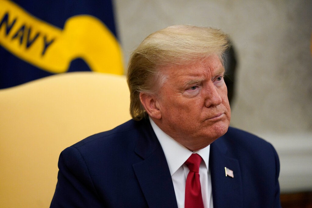 (AP Photo/Evan Vucci) President Donald Trump listens during a meeting about the coronavirus response with Gov. Greg Abbott, R-Texas, in the Oval Office of the White House, Thursday, May 7, 2020, in Washington.