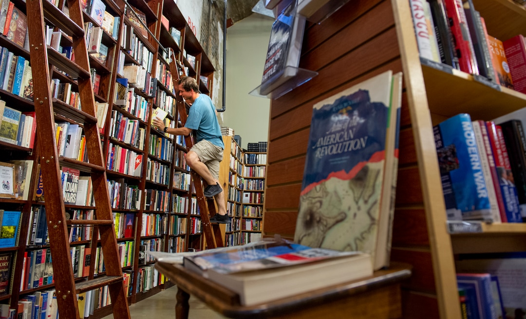 (Leah Hogsten  |  The Salt Lake Tribune) Weller Book Works employee Chance Miller shelves newly acquired books, August 7, 2019. Weller Book Works — formerly Zion Bookstore and Sam Weller's Books — is celebrating its 90th year.