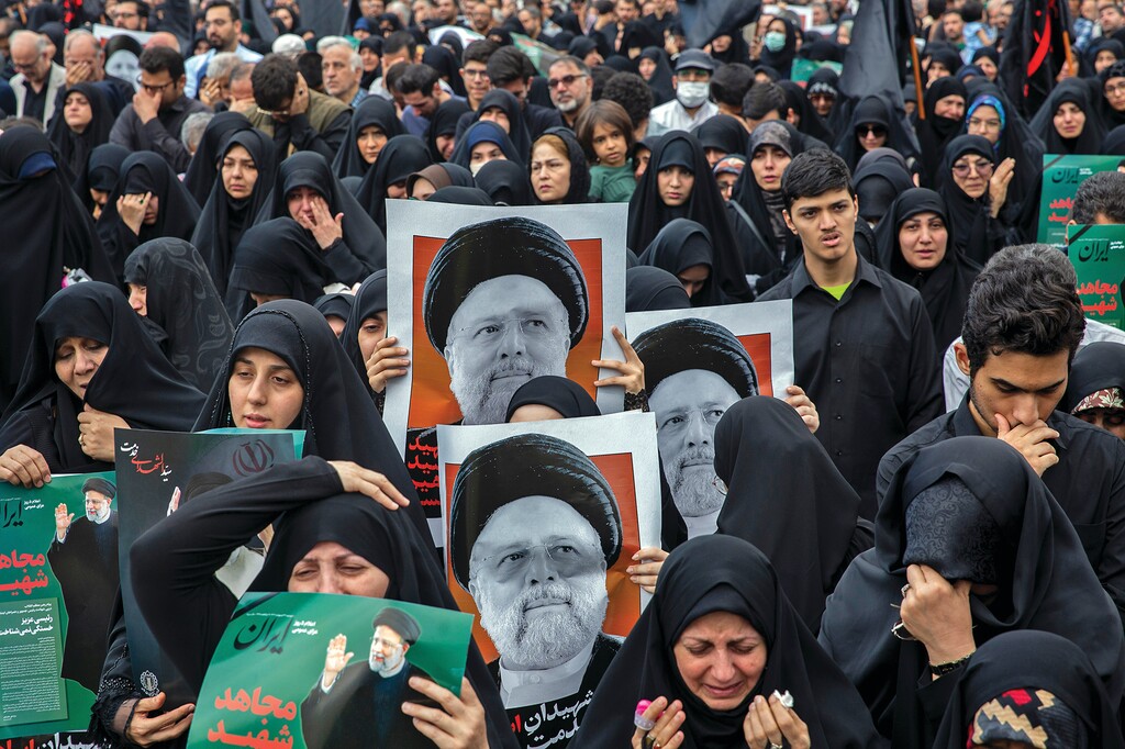 People in Tehran on Monday, May 20, 2024, carry images of President Ebrahim Raisi of Iran as they mourn his death in a helicopter crash on Sunday. The deaths of Raisi and Foreign Minister Hossein Amir Abdollahian left the country without two of its most influential figures at a moment of regional and domestic tumult.
(Arash Khamooshi/The New York Times)