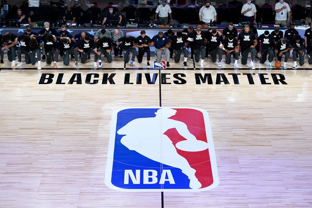 (Ashley Landis | AP photo)

Members of the New Orleans Pelicans and Utah Jazz kneel together around the Black Lives Matter logo on the court during the national anthem before the start of an NBA basketball game July 30, in Lake Buena Vista, Fla.