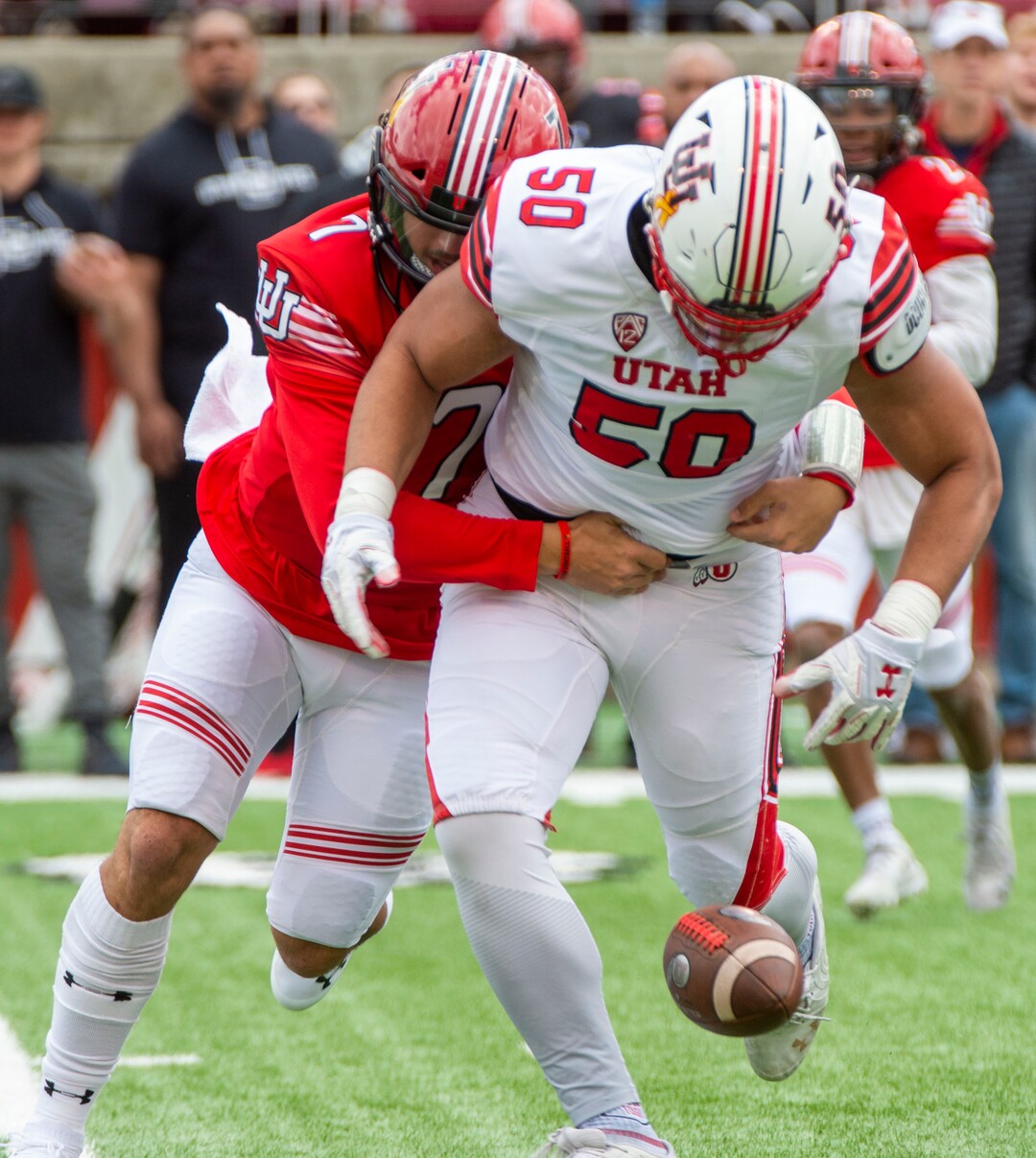 (Rick Egan  |  The Salt Lake Tribune)  Quarterback Cameraon Rising, (7) attempts to wrestle the ball back, after offensive lineman, Orlando Umana pickup his fumble, for a receiver, in Utah's spring Red-White game at Rice-Eccles Stadium, Saturday, April 13, 2019.