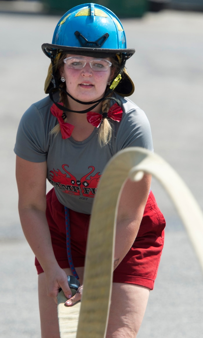 (Rick Egan  |  The Salt Lake Tribune)  Victoria straightened out a hose, while attending Camp Fury.  A dozen Utah Girl Scouts participated in a 3-day camp led by female firefighters. Camp Fury Utah was developed in partnership with the Girl Scouts and local fire and police departments, designed to expose teen girls to careers in public safety and other non-traditional jobs. Saturday, August 5, 2017.


