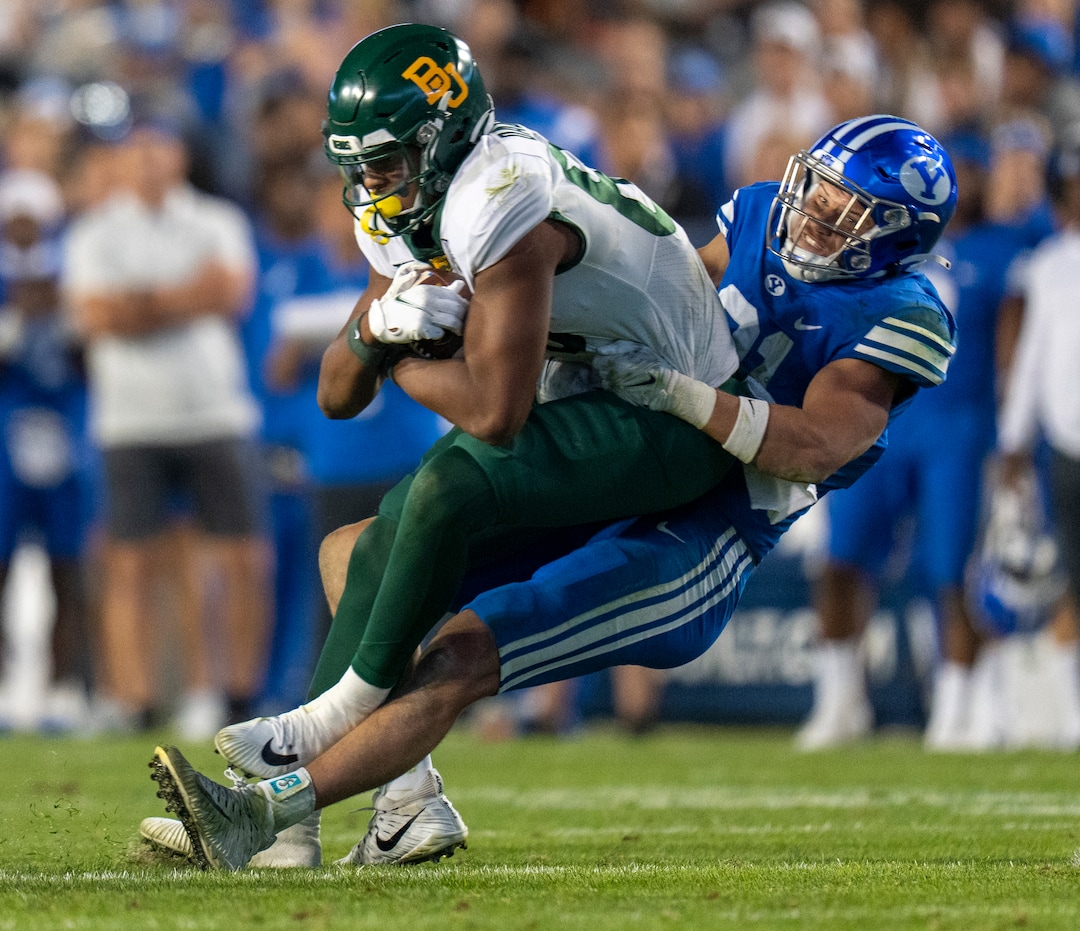 (Rick Egan | The Salt Lake Tribune) Brigham Young Cougars linebacker Max Tooley (31) pulls Baylor Bears tight end Drake Dabney (89) down to the ground, in football action between the Brigham Young Cougars and the Baylor Bears at LaVell Edwards Stadium in Provo, on Saturday, Sept. 10, 2022.
